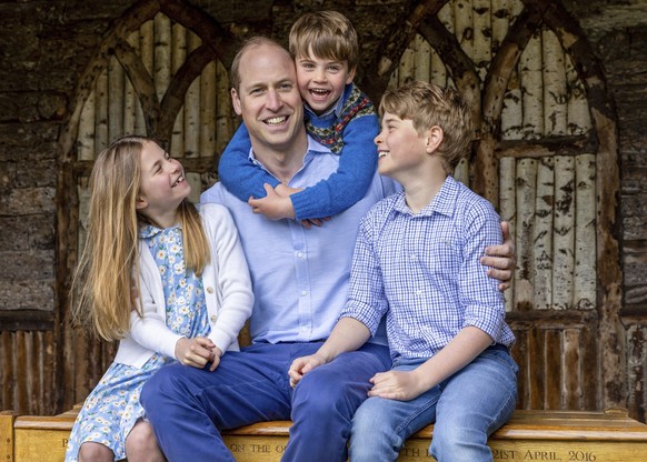 William, the Prince of Wales, sits with his children Princess Charlotte, Prince Louis and Prince George, right, Saturday June 17, 2023, ahead of Father&#039;s Day. (Millie Pilkington/Kensington Palace ...