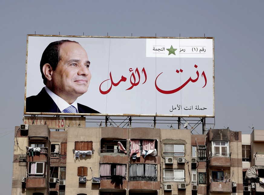 In this Monday, March 19, 2018 photo, an election banner for Egyptian President Abdel-Fattah el-Sissi hangs on top of a residential building with Arabic that reads, &quot;you are the hope,&quot; on th ...
