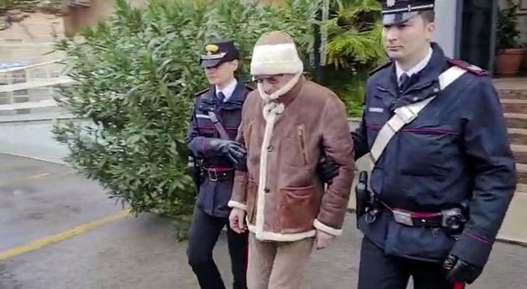 FILE - In this picture taken from a video released by Italian Carabinieri on Monday, Jan. 16, 2023, top Mafia boss Matteo Messina Denaro, center, leaves an Italian Carabinieri barrack soon after his a ...