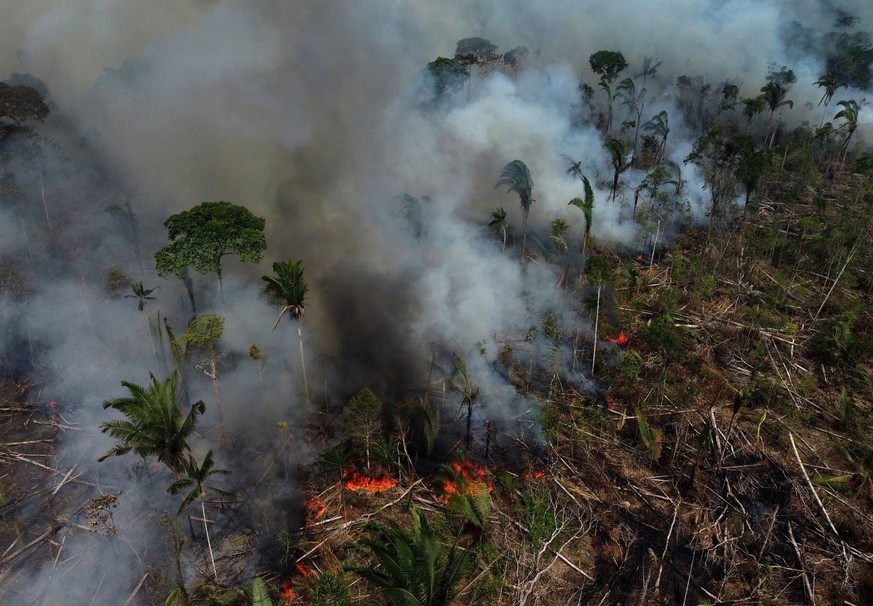 FILE - Smoke rises from a forest fire in the Transamazonica highway region, in the municipality of Labrea, Amazonas state, Brazil, Sept. 17, 2022. Despite the smoke clogging the air of entire Amazon c ...