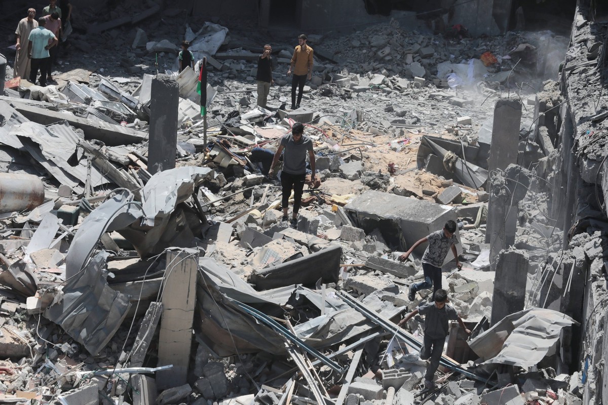 Palestinians search the rubble of the Harb family home which was hit in overnight Israeli strikes in al-Bureij refugee camp Palestinians search the rubble of the Harb family home which was hit in over ...