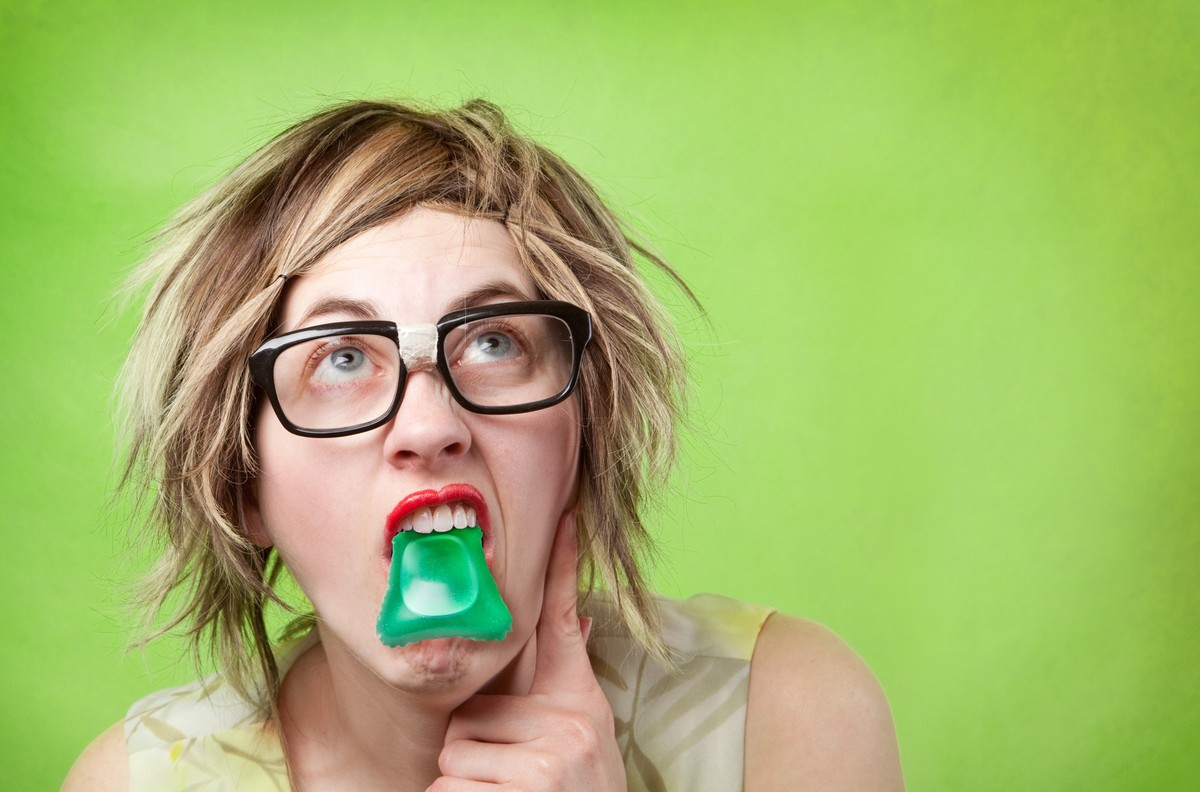 A clueless woman with a laundry pod in her mouth.
