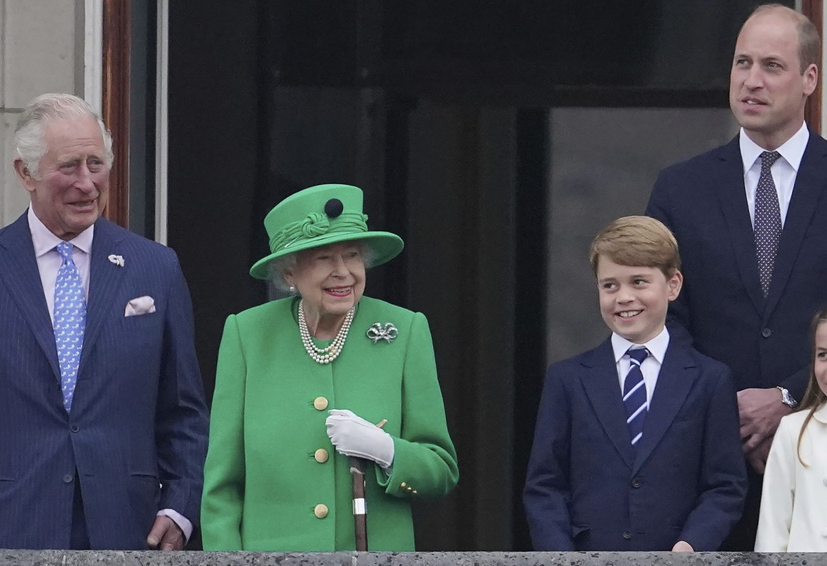 From left, Prince Charles, Queen Elizabeth II, Prince George and Prince William appear on the balcony of Buckingham Palace during the Platinum Jubilee Pageant outside Buckingham Palace in London, Sund ...