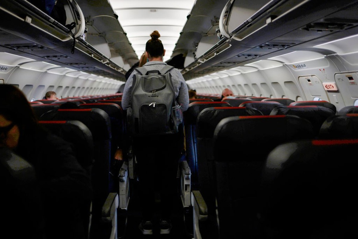 DALLAS, TX - NOVEMBER 24: A passenger boards an airplane at the Dallas/Fort Worth International Airport on November 24, 2021 in Dallas, Texas. FAA expects the number of travelers for Thanksgiving to r ...