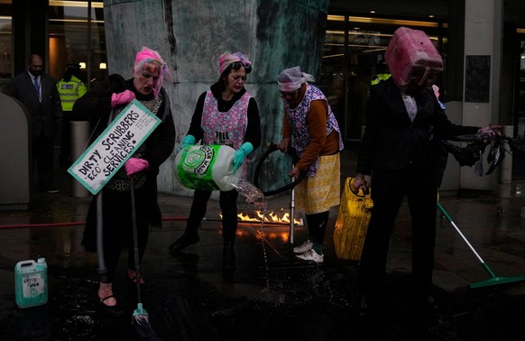 Ocean Rebellion demonstrators protest outside the International Maritime Organisation against the use of fossil fuels in the shipping industry, in London, Monday, Nov. 21, 2022. (AP Photo/Alastair Gra ...