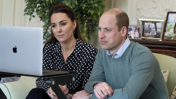In this undated photo issued by Kensington Palace on Friday, March 5, 2021, Britain&#039;s Prince William and Kate the Duchess of Cambridge take part in a videocall with the parents of a schoolboy who ...