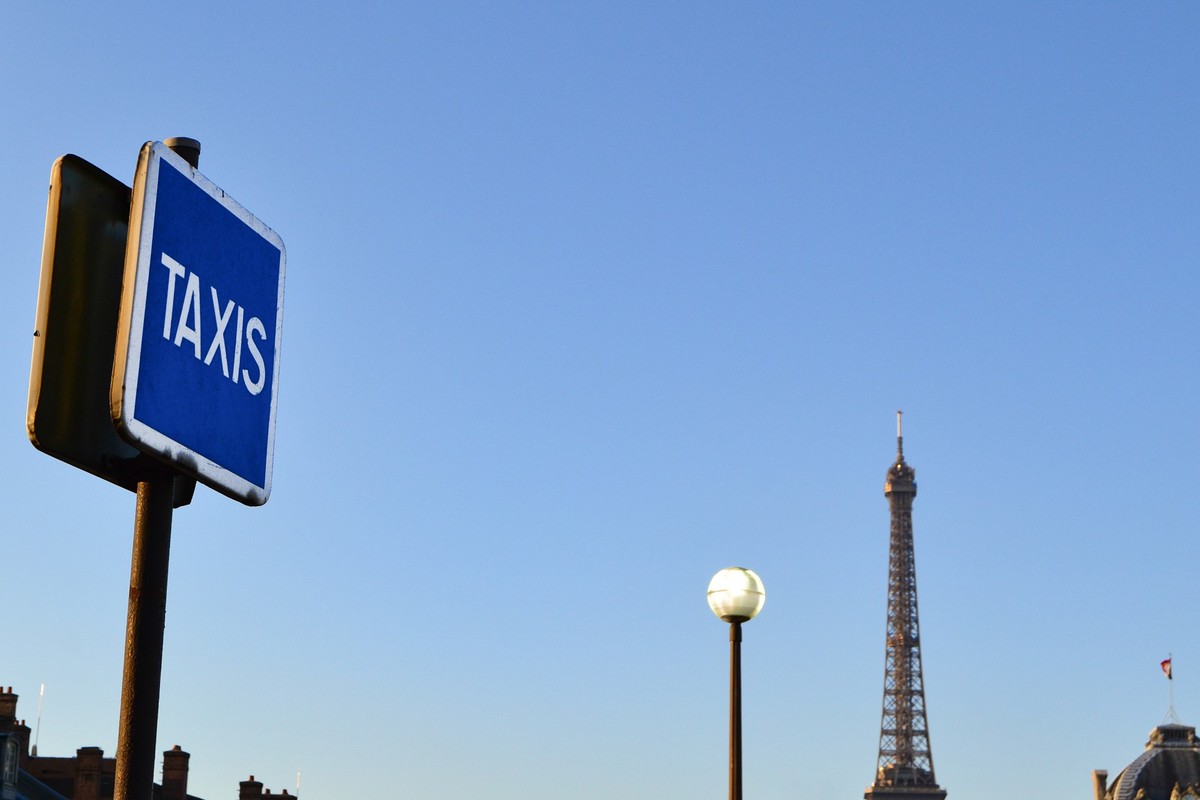 Paris skyline at morning with Eiffel Tower and urban elements such as: a taxi sign, chimneys, street light. xkwx city, architecture, sky, building, blue, urban, travel, tower, landmark, skyline, citys ...