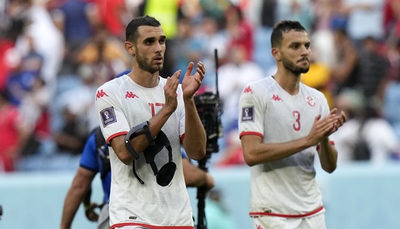 Tunisia's Ellyes Skhiri and Tunisia's Montassar Talbi walk to their fans after losing the World Cup group D soccer match between Tunisia and Australia at the Al Janoub Stadium in Al Wakrah, Qatar, Sat ...