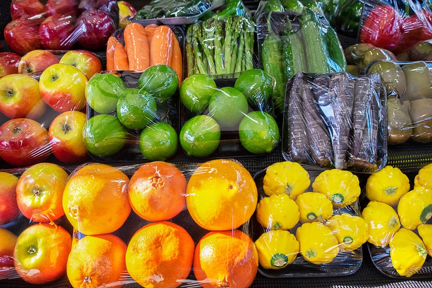 Close up of fresh, plastic wrapped vegetable varieties at a Farmer&#039;s Market in Victoria, Australia during the winter season.