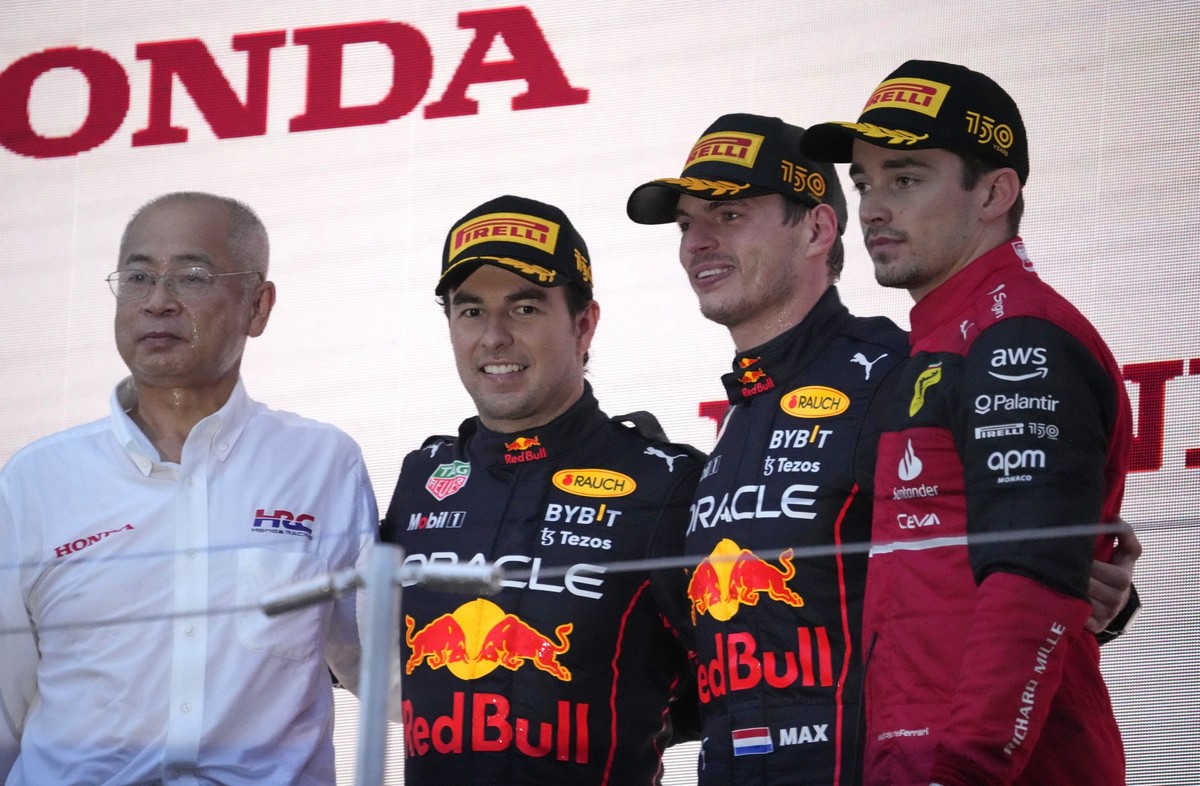 Red Bull driver Max Verstappen, second right, of the Netherlands poses with second placed teammate Sergio Perez, third right, of Mexico and Ferrari driver Charles Leclerc of Monaco during the Japanese ...
