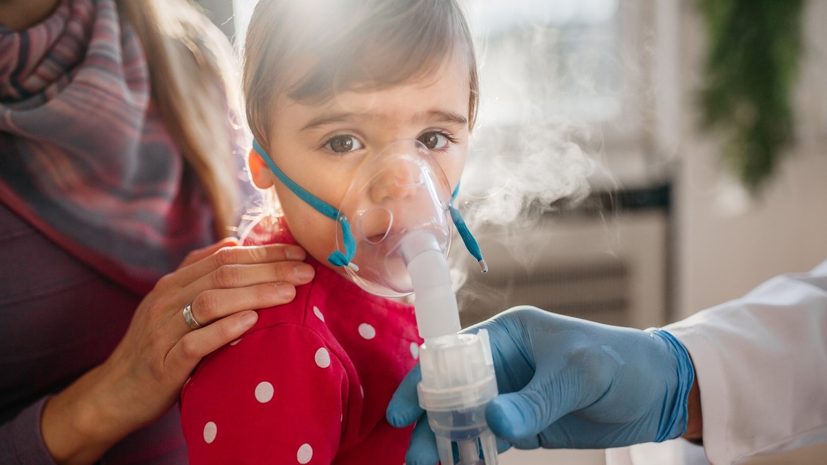 Asthma, little girl with inhaling mask
