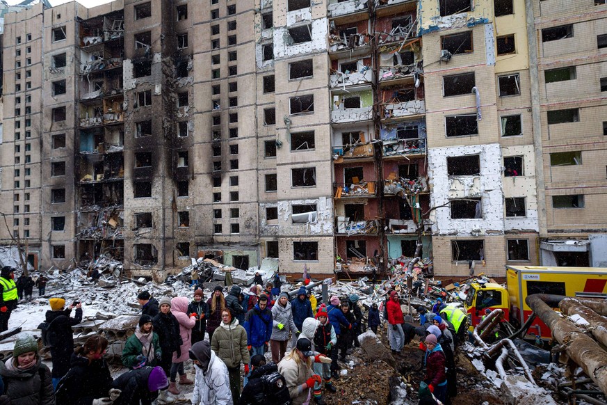 Russian Missiles Pound Kyiv Residents remove the rubble outside an apartment building in the Solomianskyi district destroyed in the Russian missile attack on Tuesday, Kyiv, capital of Ukraine, January ...