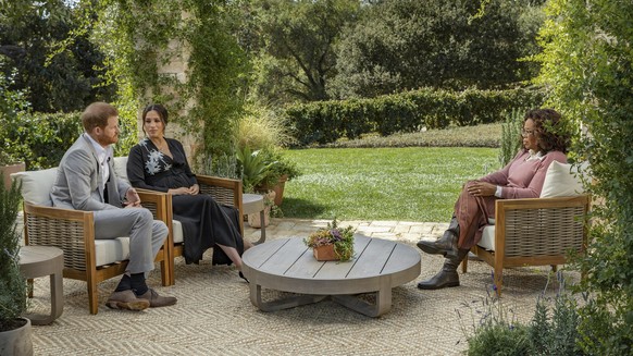 This image provided by Harpo Productions shows Prince Harry, from left, and Meghan, The Duchess of Sussex, in conversation with Oprah Winfrey. (Joe Pugliese/Harpo Productions via AP)