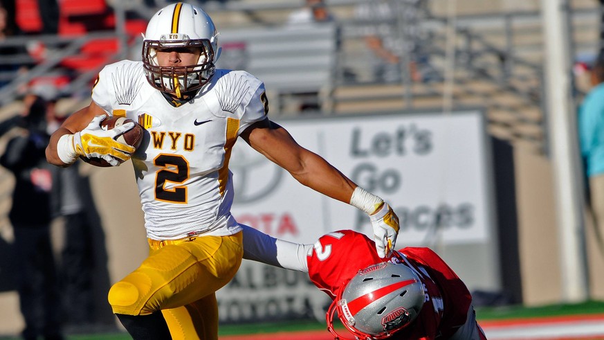 Nov. 29, 2014 - Albuquerque, NM, U.S. - Wyoming s 2 Eric Nzeocha pushes off the UNM tackler 12 Ryan Santos as he takes the ball down field. Saturday, Nov. 29, 2014. News - Nov. 29, 2014 PUBLICATIONxIN ...