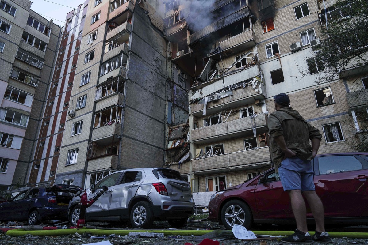 A man looks at his apartment building which was heavily damaged by a Russian strike on a residential neighborhood in Kyiv, Ukraine, on Sunday, Sept. 7, 2025. (AP Photo/Evgeniy Maloletka)