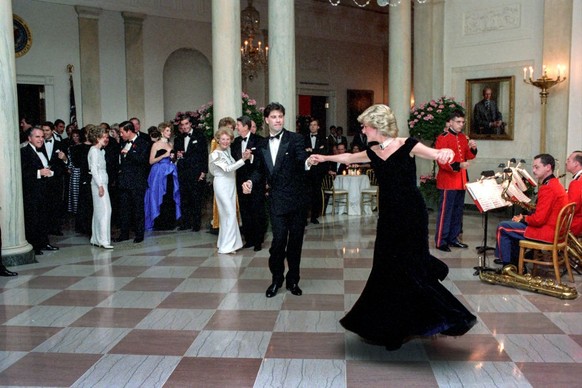 WASHINGTON, DC - NOVEMBER 9, 1985: In this handout image provided by The White House, Princess Diana dances with John Travolta in Cross Hall at the White House during an official dinner on November 9, ...
