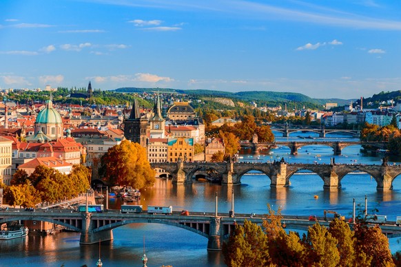 View of the Vltava River and Charle bridge with red foliage, Prague, Czech Republic