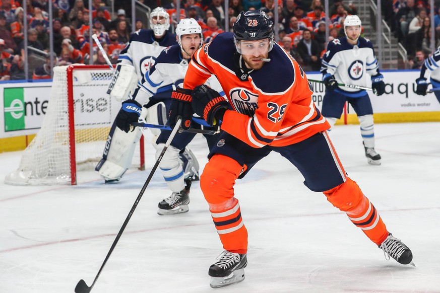 EDMONTON, AB - MARCH 11: Edmonton Oilers Center Leon Draisaitl 29 chases down a loose puck in the third period during the Edmonton Oilers game versus the Winnipeg Jets on March 11, 2020 at Rogers Plac ...