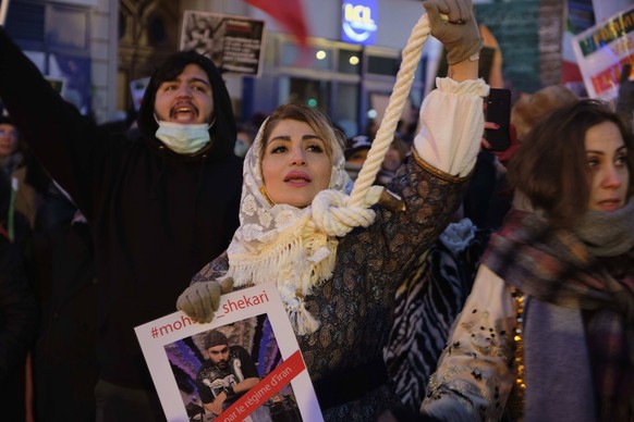 December 11, 2022, Paris, Ile de France, FRANCE: A woman holding a noose around her neck participates in a march in Paris to denounce the Islamic regime in Iran. Mohsen Shekari was the first Iranian t ...