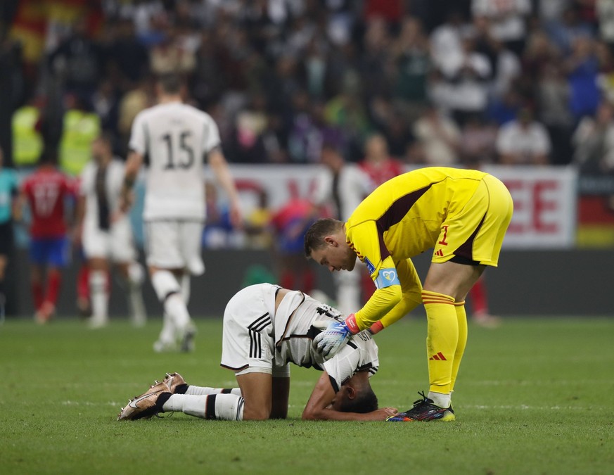 Costa Rica v Germany 2022 FIFA World Cup, WM, Weltmeisterschaft, Fussball Germany goalkeeper Manuel Neuer checks on team-mates Jamal Musiala during the 2022 FIFA World Cup Group E match at Al Bayt Sta ...