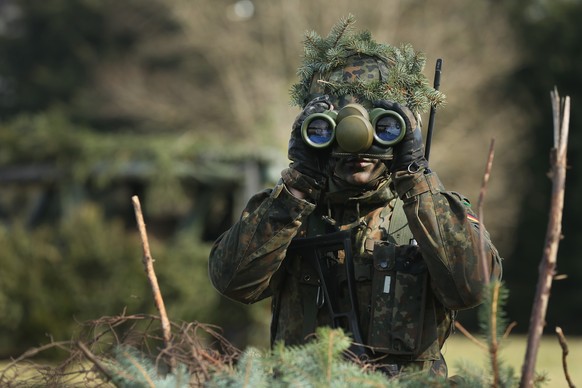 MARIENBERG, GERMANY - MARCH 10: A member of the German Bundeswehr&#039;s 371st Armoured Infantry Battalion (Panzergredanadierbataillon 371) looks through binoculaurs during a media event at the battal ...