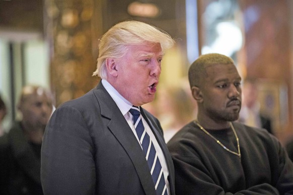 December 13, 2016 - New York, New York, United States of America - United States President-elect Donald J. Trump and Musician Kanye West pose for photographers in the lobby of Trump Tower in Manhattan ...