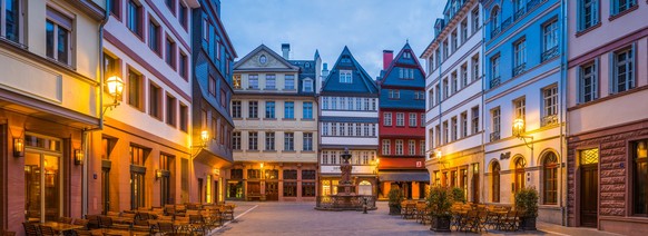 The reconstructed historic restaurants, villas and stores of the Dom-Romer Project in the Altstadt Old Town district of central Frankfurt am Main illuminated by warm lamplight at night, Hesse, Germany ...