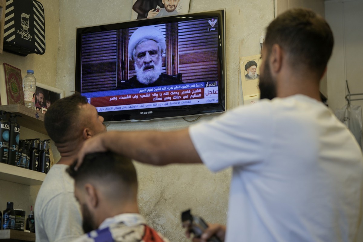 30.09.2024, Libanon, Beirut: Menschen sehen in einem Friseursalon eine Rede des stellvertretenden Hisbollah-Führers Scheich Naim Kassim, die vom Hisbollah-Fernsehsender al-Manar ausgestrahlt wird. Fot ...