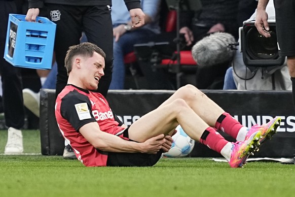 Leverkusen&#039;s Florian Wirtz gets injured and has to leave the pitch during the Bundesliga soccer match between Bayer Leverkusen and Werder Bremen at the BayArena in Leverkusen, Germany, Saturday,  ...