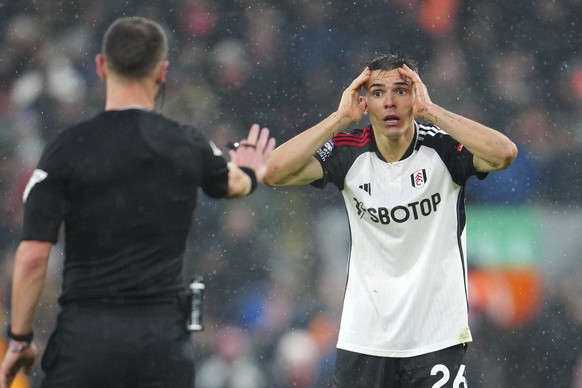 Fulham&#039;s Joao Palhinha, right, reacts during the English Premier League soccer match between Liverpool and Fulham at the Anfield stadium in Liverpool, England, Sunday, Dec. 3, 2023. (AP Photo/Jon ...
