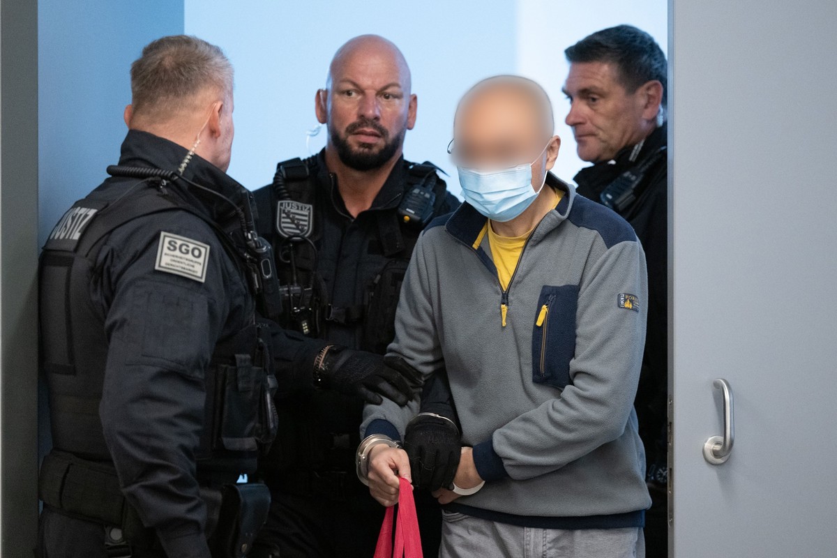 ARCHIV - 05.08.2025, Sachsen, Dresden: Der Hauptangeklagte Jian G. (2.v.r.) wird vor Prozessbeginn in den Gerichtssaal geführt. (zu dpa: «Ehemaliger Krah-Mitarbeiter wegen Spionage verurteilt») Foto:  ...