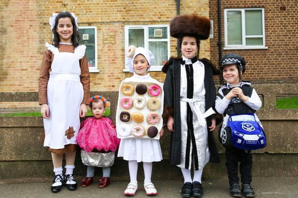 March 21, 2019 - London, UK, United Kingdom - Orthodox couple seen wearing fancy dresses during the festival of Purim on the streets of Stamford Hill in north London..Purim is one of the most entertai ...