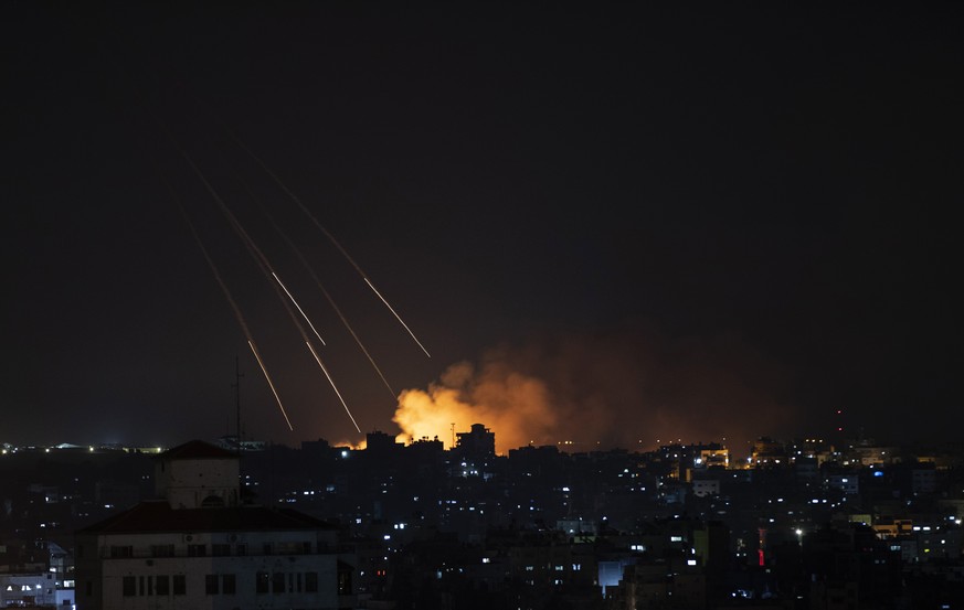 Smoke rises following Israeli missile strikes on Gaza City, Thursday, May 13, 2021. The four-day burst of violence has pushed Israel into uncharted territory — dealing with the most intense fighting i ...