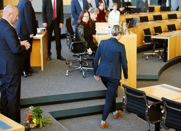 Susanne Hennig-Wellsow of the Left Party (Die Linke) walks away after throwing flowers in front of Free Democratic Party (FDP) candidate Thomas Kemmerich after he was elected new Thuringia premier at  ...