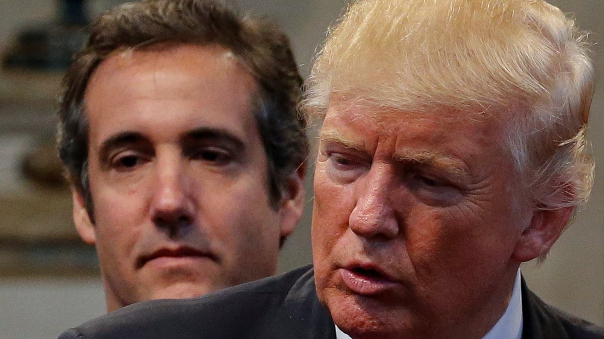 Republican presidential nominee Donald Trump&#039;s personal attorney Michael Cohen stands behind Trump as a group of supporters lay hands on Trump in prayer during a campaign stop at the New Spirit R ...