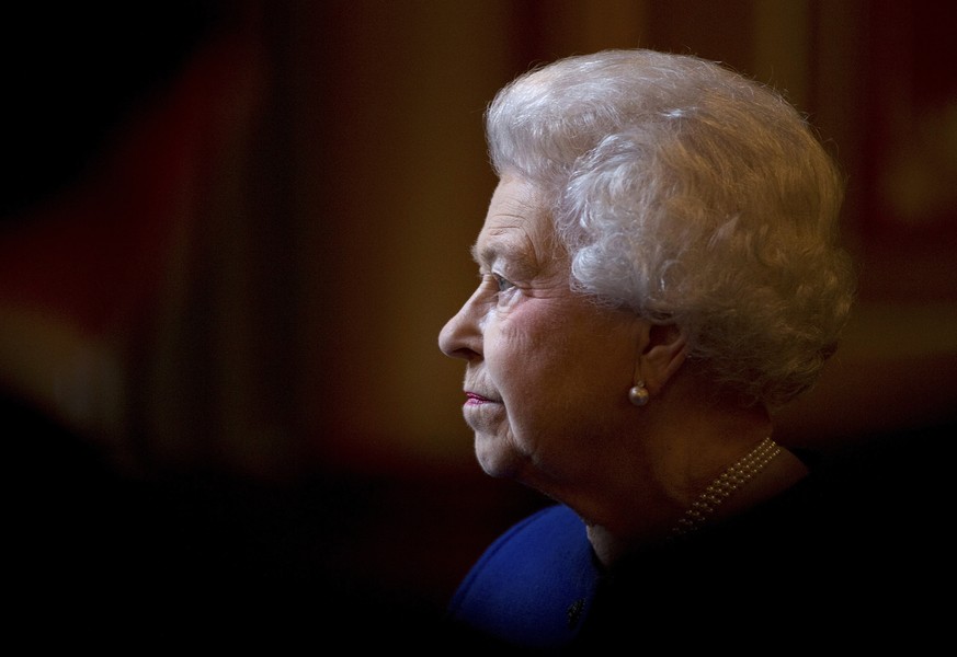 FILE - Britain&#039;s Queen Elizabeth II escorted by British Foreign Secretary William Hague, tours the Foreign and Commonwealth Office during an official visit which is part of her Jubilee celebratio ...