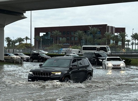 Cars drive through flood water caused by heavy rains, in Dubai, United Arab Emirates, March 9, 2024. REUTERS/Abdelhadi Ramahi