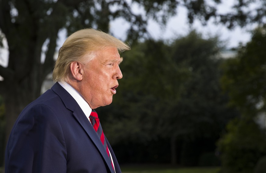President Donald Trump speaks with reporters before departing on Marine One from the South Lawn of the White House, Thursday, Sept. 12, 2019, in Washington. Trump is en route to Baltimore.(AP Photo/Al ...