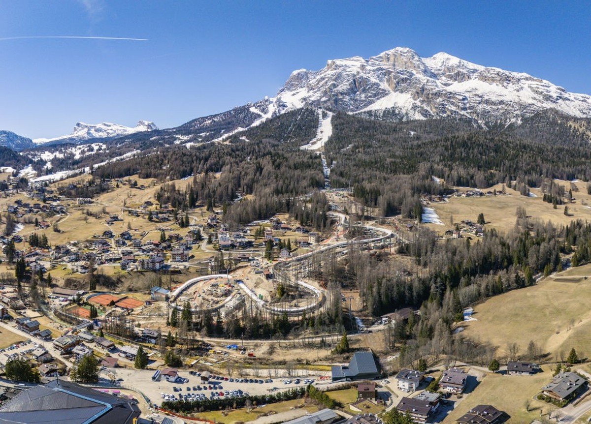 CORTINA D&#039;AMPEZZO, ITALY - MARCH 20: An aerial view of the Cortina d&#039;Ampezzo valley, with the bobsleigh track for the upcoming Winter Olympics in the foreground, surrounded by an almost comp ...