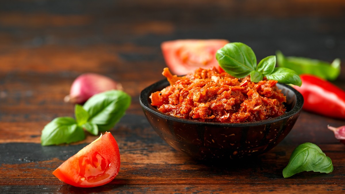 Sun dried tomato pesto with chilli, garlic and herbs in bowl. xkwx background, food, vintage, sun, leaf, pesto, red, tomato, italian, vegetarian, vegetable, sauce, healthy, ingredient, dried, garlic, ...