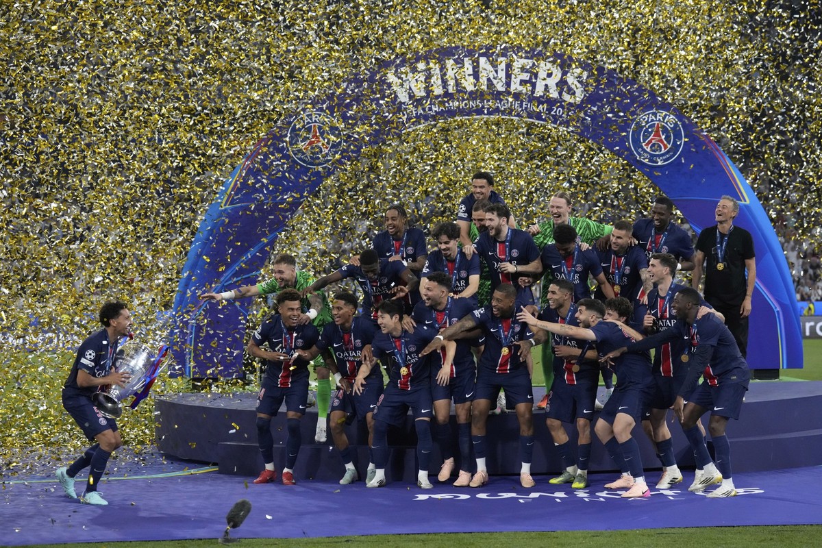 PSG players celebrate with the trophy after winning the Champions League final soccer match between Paris Saint-Germain and Inter Milan at the Allianz Arena in Munich, Germany, Saturday, May 31, 2025. ...