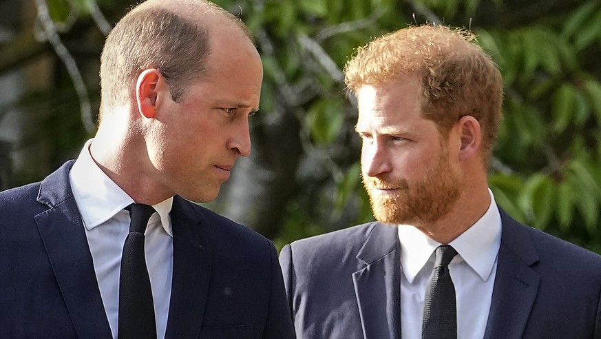 FILE - Britain&#039;s Prince William and Britain&#039;s Prince Harry walk beside each other after viewing the floral tributes for the late Queen Elizabeth II outside Windsor Castle, in Windsor, Englan ...