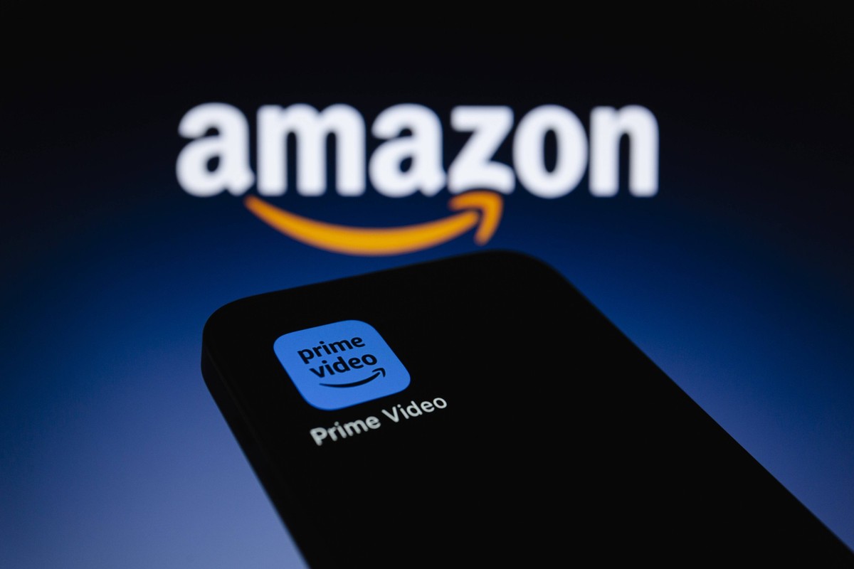 September 22, 2023, Asuncion, Paraguay: Prime Video app icon is displayed on a smartphone backdropped by Amazon logo. Starting in early 2024, Prime Video shows and movies will include limited advertis ...