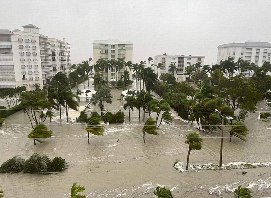 The storm surge from Hurricane Ian sends water through the streets of Naples, Florida in this handout image taken Wednesday, September 28, 2022. More than 2 million people throughout the state of Flor ...