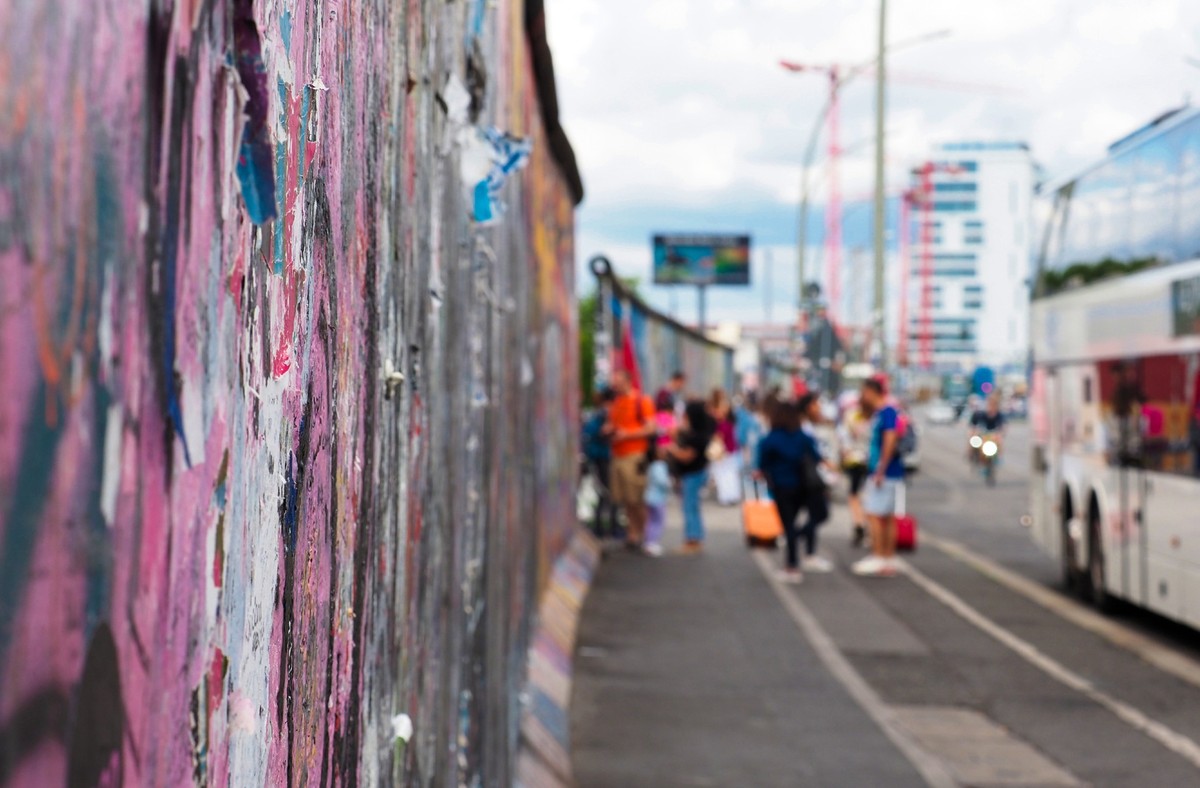 Tourists at the Berlin Wall. Berlin, Germany. East Side Gallery, Berlin wall section