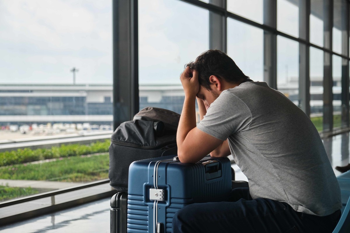 Frustrated man at Narita airport, annoyed because his flight was canceled. Model Released Property Released xkwx frustrated man airport annoyed flight canceled narita japan person luggage passenger tr ...