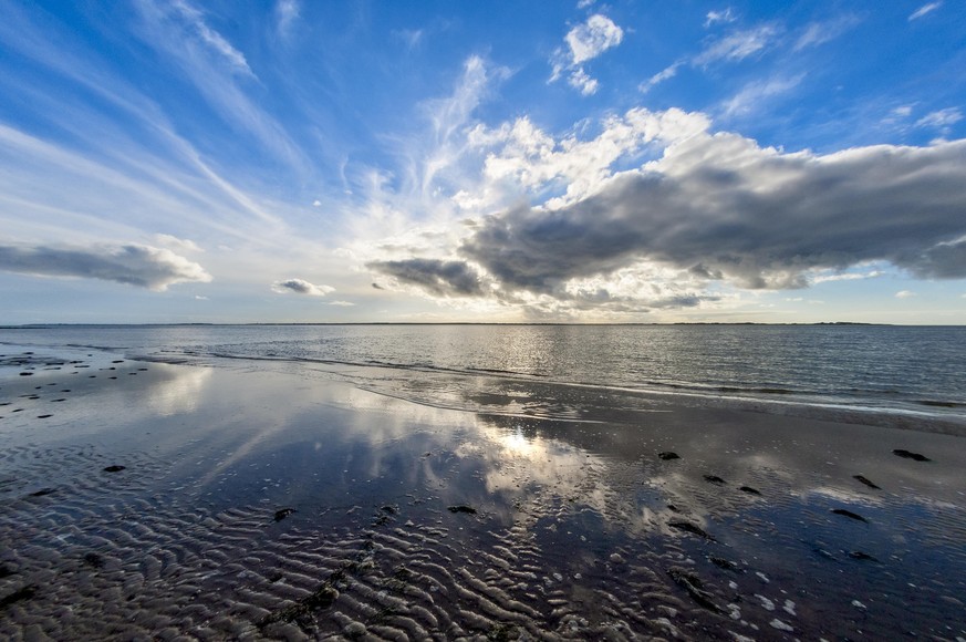 Clouds and their reflection in the Wadden Sea at low tide on the North Sea island of Föhr