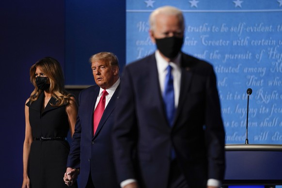 FILE - In this Oct. 22, 2020, file photo first lady Melania Trump, left, and President Donald Trump, center, remain on stage as Democratic presidential candidate former Vice President Joe Biden, right ...