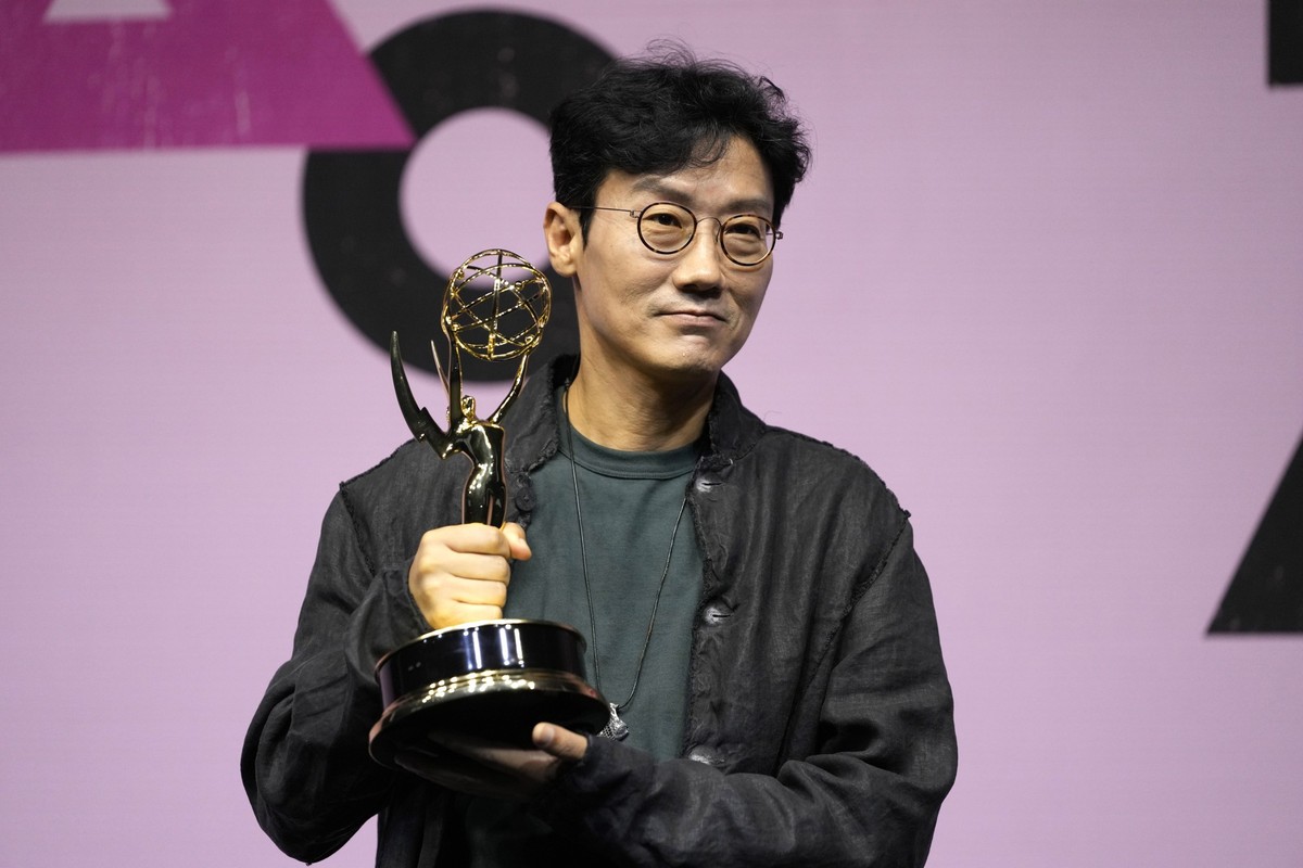 Squid Game&#039;s director Hwang Dong-hyuk poses with a trophy for the media during an Emmys celebration news conference for &quot;Squid Game&quot; in Seoul, South Korea, Friday, Sept. 16, 2022. The N ...
