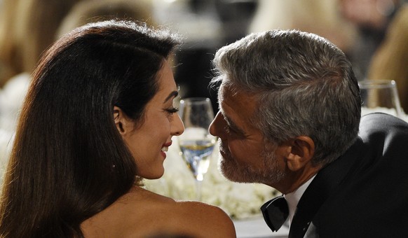 Actor/director George Clooney, right, and his wife Amal mingle during the 46th AFI Life Achievement Award gala ceremony honoring him at the Dolby Theatre, Thursday, June 7, 2018, in Los Angeles. (Phot ...